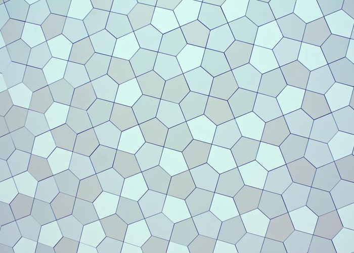 Overhead view of creative abstract backdrop with seamless pattern representing small pentagons with straight lines